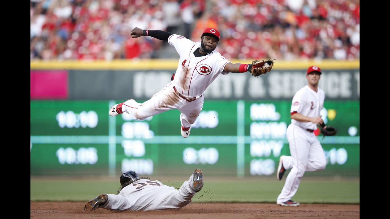 Cincinnati's Brandon Phillips leaps over San Francisco's Brandon Crawford as Crawford steals second base Friday, May 15, in Cincinnati.
