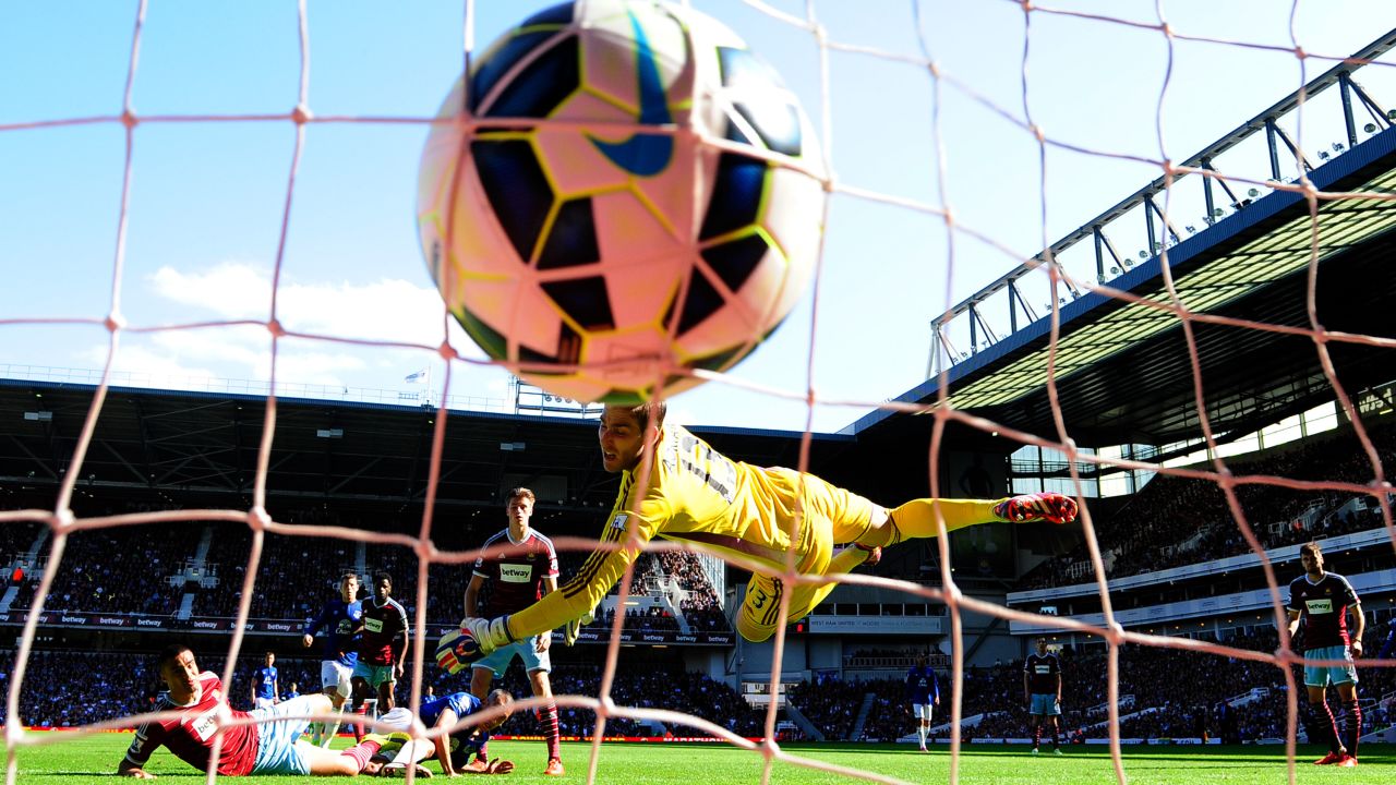 Everton's Leon Osman, on the ground in blue, scores a goal against West Ham during a Premier League match played Saturday, May 16, in London. Everton won the match 2-1.