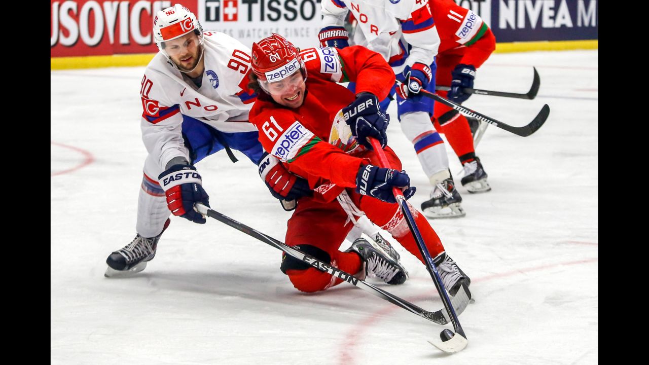 Norway's Daniel Sorvik, left, and Belarus' Andrei Stepanov battle for the puck during a game at the Ice Hockey World Championship on Tuesday, May 12.