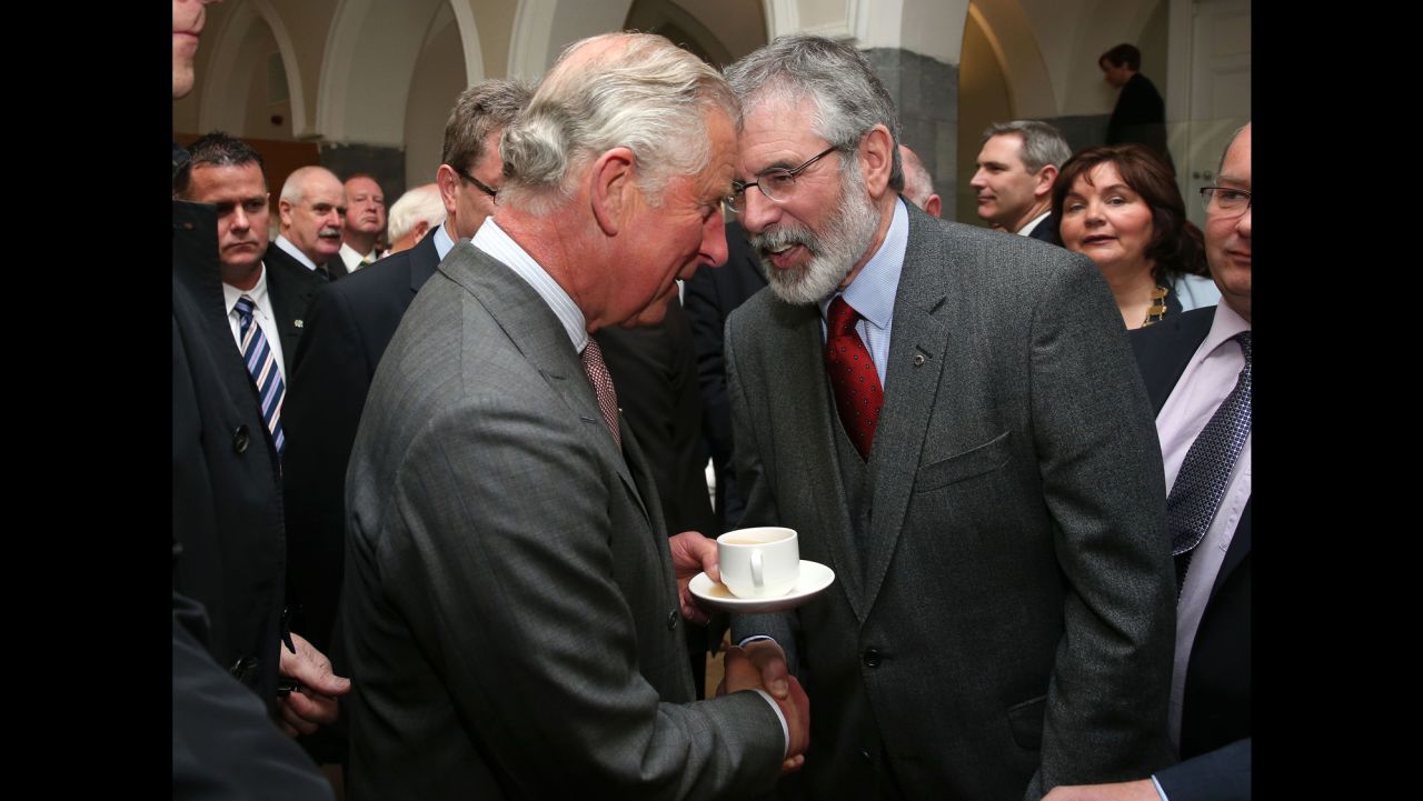 Britain's Prince Charles. left, shakes hands with Sinn Fein president Gerry Adams at the National University of Ireland in Galway, Ireland, Tuesday May 19, 2015. Prince Charles has begun an official visit to Ireland featuring two new milestones of peacemaking: his first meeting with leaders of the Irish nationalist Sinn Fein party, and his first trip to the fishing village where the Irish Republican Army killed his great-uncle 36 years ago. It is Charles' third trip to the Irish Republic since the outlawed IRA called a 1994 cease-fire. (Brian Lawless/Pool photo via AP)