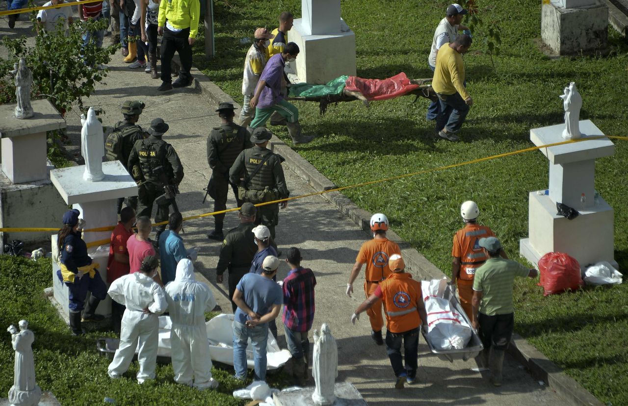 Rescue workers carry corpses after the disaster.