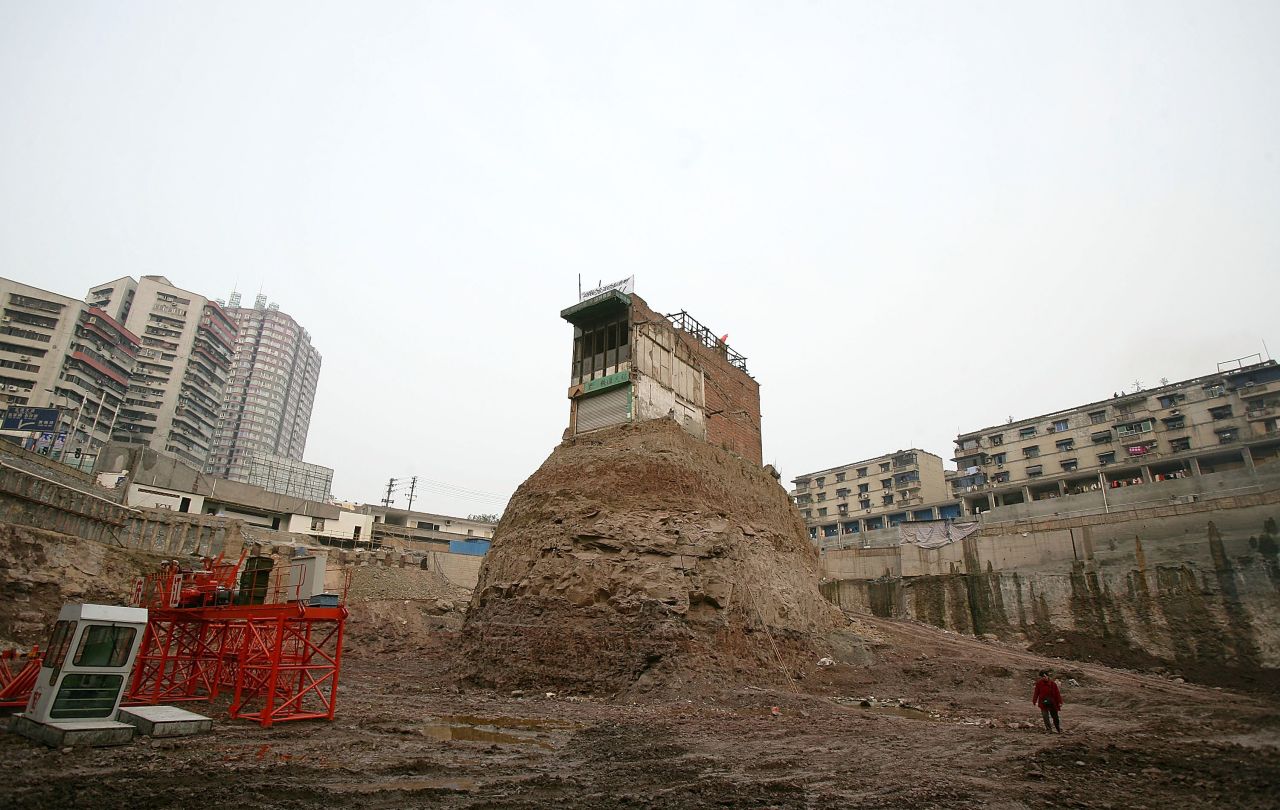 One of the most famous "nail houses" was a building in Chongqing, western China. The homeowner hung a banner and the national flag in protest and refused to sell to a developer who went ahead with construction around the site in 2007.