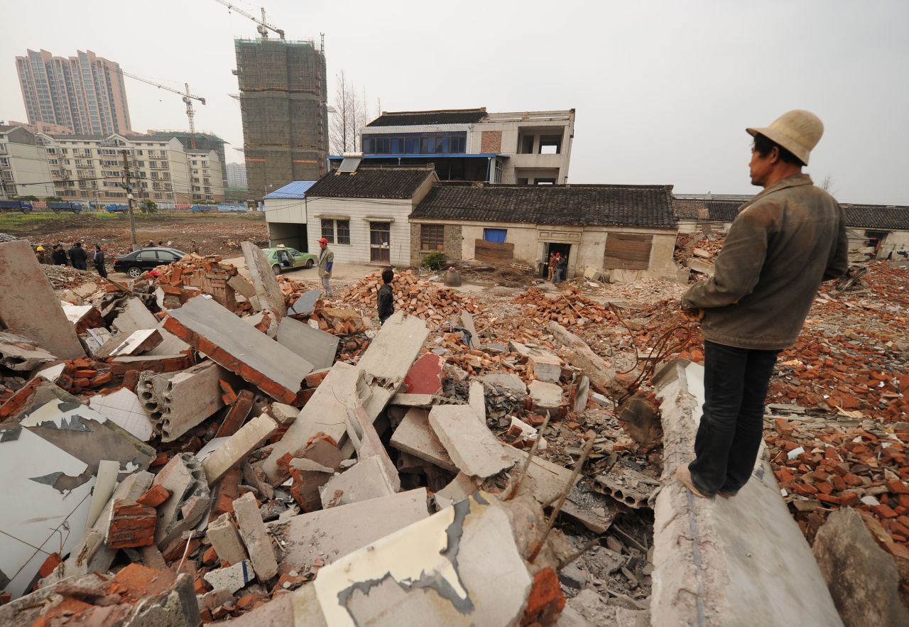 This picture taken on March 13, 2013 shows a worker looking out over a rubble-filled construction site where 75-year-old Yao Baohua's house still stands in Changzhou, a city in eastern China's Jiangsu province.