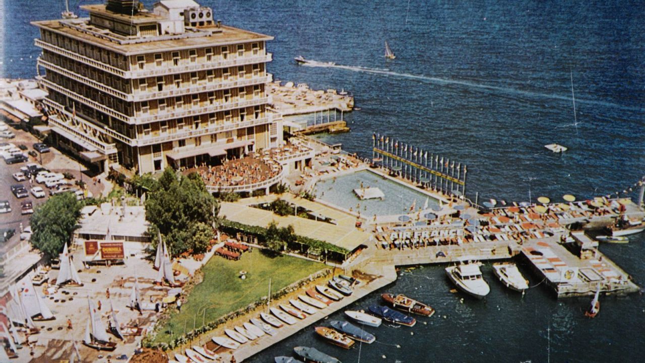 The hotel restaurant and bar, with its semicircular terrace looking over the pool and beach below, were ground zero for the city's foreign correspondents, either resident or passing through. 