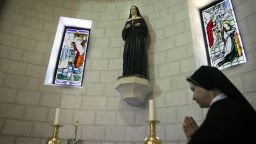 A sister prays in front of relics of Marie Alphonsine Ghattas at the Mamilla monastery in Jerusalem on May 12, 2015, a few days ahead of the canonisation of the Palestinian nun in Rome.