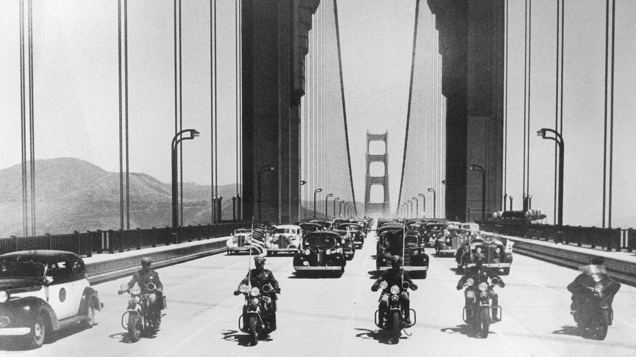 The first vehicles, led by a police escort, cross the bridge and head south into San Francisco on May 28, 1937. The structure was once the longest suspension bridge in the world, although it was surpassed in 1964 with the completion of the Verrazano-Narrows Bridge in New York.