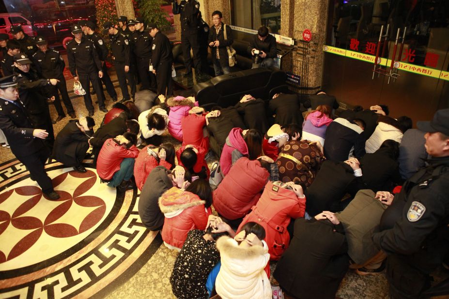 This picture taken on February 9, 2014 shows Chinese police rounding up alleged sex workers and clients. The raids lasted several months and their impact is still being felt more than a year later. 
