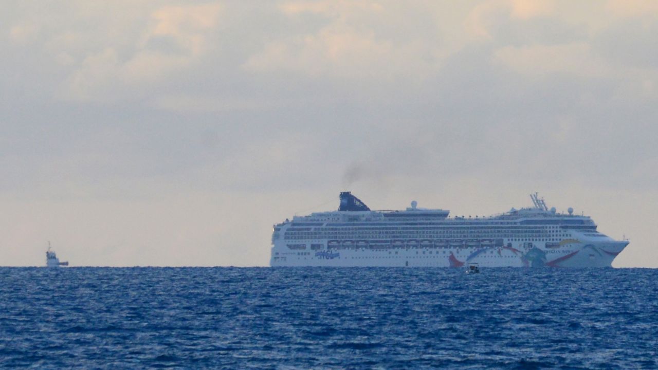 The cruise ship Norwegian Dawn sits aground near Bermuda's North Channel on Tuesday, May 19. "Norwegian Dawn temporarily lost power as the ship was departing King's Wharf, Bermuda. The ship's propulsion was affected and, at which time, the vessel made contact with the channel bed. All guests and crew are safe," spokeswoman Vanessa Picariello said. 
