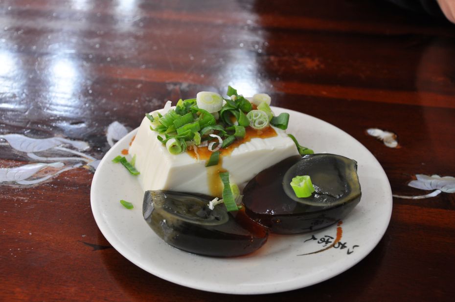 The thousand year egg, or pidan, is a delicacy throughout China. Wrapped in clay and buried in the ground for several months, during that time the yolk turns gray and the whites a jelly-like brown, taking on a salty flavor.