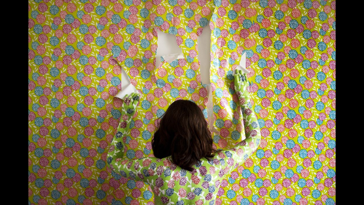 A woman matches her wallpaper in this photo from Keyana Tahmaseb's "Human Canvas" series. "I wanted the subject to look more than trapped ... like she was trying to break out of that feeling," Tahmaseb said.