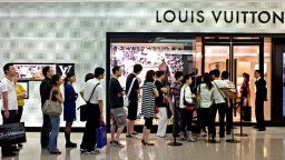 In a picture taken on June 14, 2010 shoppers queue to enter a shop of French luxury brand Louis Vuitton in a shopping mall in Shanghai. Following in the footsteps of Japan, China has become the world's second-largest consumer of high-end fashion, accessories and luxury goods.