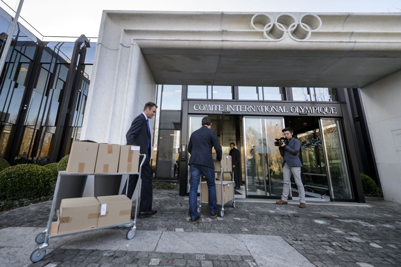 Staff carry the 2022 Winter Olympic bid files of Almaty, Kazakhstan on January 6, 2015 at the International Olympic Committee headquarters in Lausanne, Switzerland. The IOC will make a final decision in July 2015. Kazakhstan is also planning to bid for football's 2026 World Cup. 