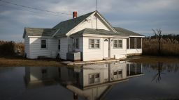 The front yard of a vacant home in Maryland is shown in 2014 flooded from rising waters.