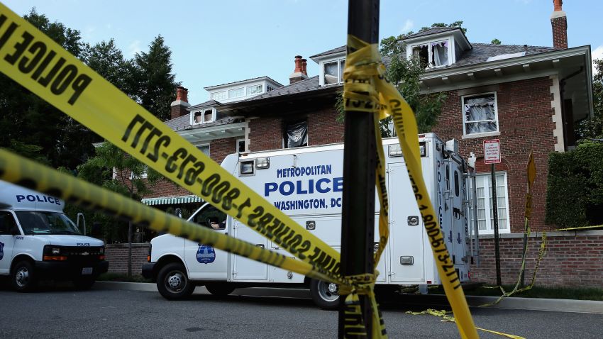 Caption:WASHINGTON, DC - MAY 19: District of Columbia Metropolitan Police maintain a perimeter around the house on the 3200 block of Woodland Drive NW May 19, 2015 in Washington, DC. Firefighters discovered the bodies of Savvas Savopoulos, 46, his wife Amy, 47, their 10-year-old son Philip, and the housekeeper, Veralicia Figueroa, 57, last Thursday afternoon when they responded to a blaze at the house. Two Savopoulos daughters were away in boarding school at the time. Investigators have ruled the deaths homicides and say they could continue to collect evidence at the house for another week. (Photo by Chip Somodevilla/Getty Images)

