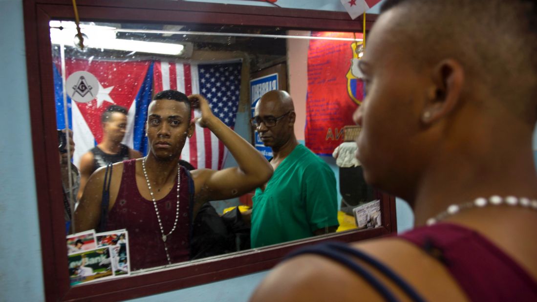 An American flag hangs next to a Cuban flag in an Havana barbershop in February.