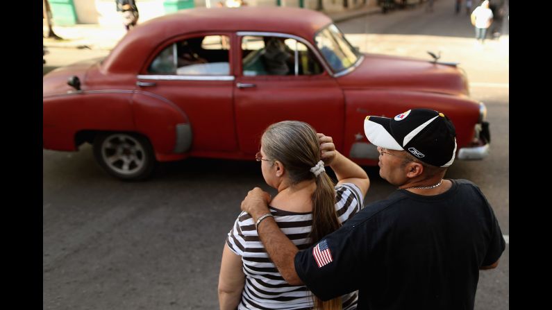 A man with the American flag on his sleeve stands with a woman in Havana in January.