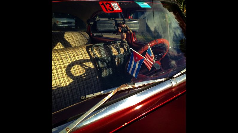 Cuban and U.S. flags decorate the dashboard of a car in Havana.