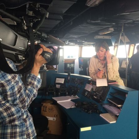The only way to communicate with the outside world from the middle of the sea is satellite phone. Here, Amanpour stands on the bridge of the frigate Virginio Fasan while <a href="index.php?page=&url=http%3A%2F%2Fwww.cnn.com%2Fvideo%2Fdata%2F2.0%2Fvideo%2Fworld%2F2015%2F05%2F20%2Famanpour-mediterranean-beeper.cnn.html" target="_blank">she speaks with CNN's Hala Gorani</a>.