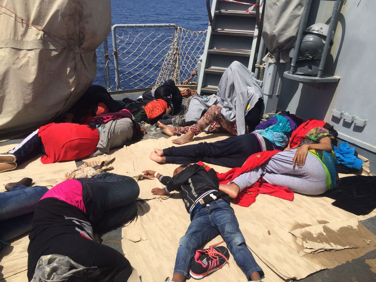 A sigh of relief: Women and children sleep on the deck of the Sfinge, an Italian Minerva-class warship -- "sfinge" is Italian for "sphinx" -- after being rescued.<br /><br />Producer Dominique van Heerden took these photos after the CNN team helicoptered in from the Italian island of Lampedusa.