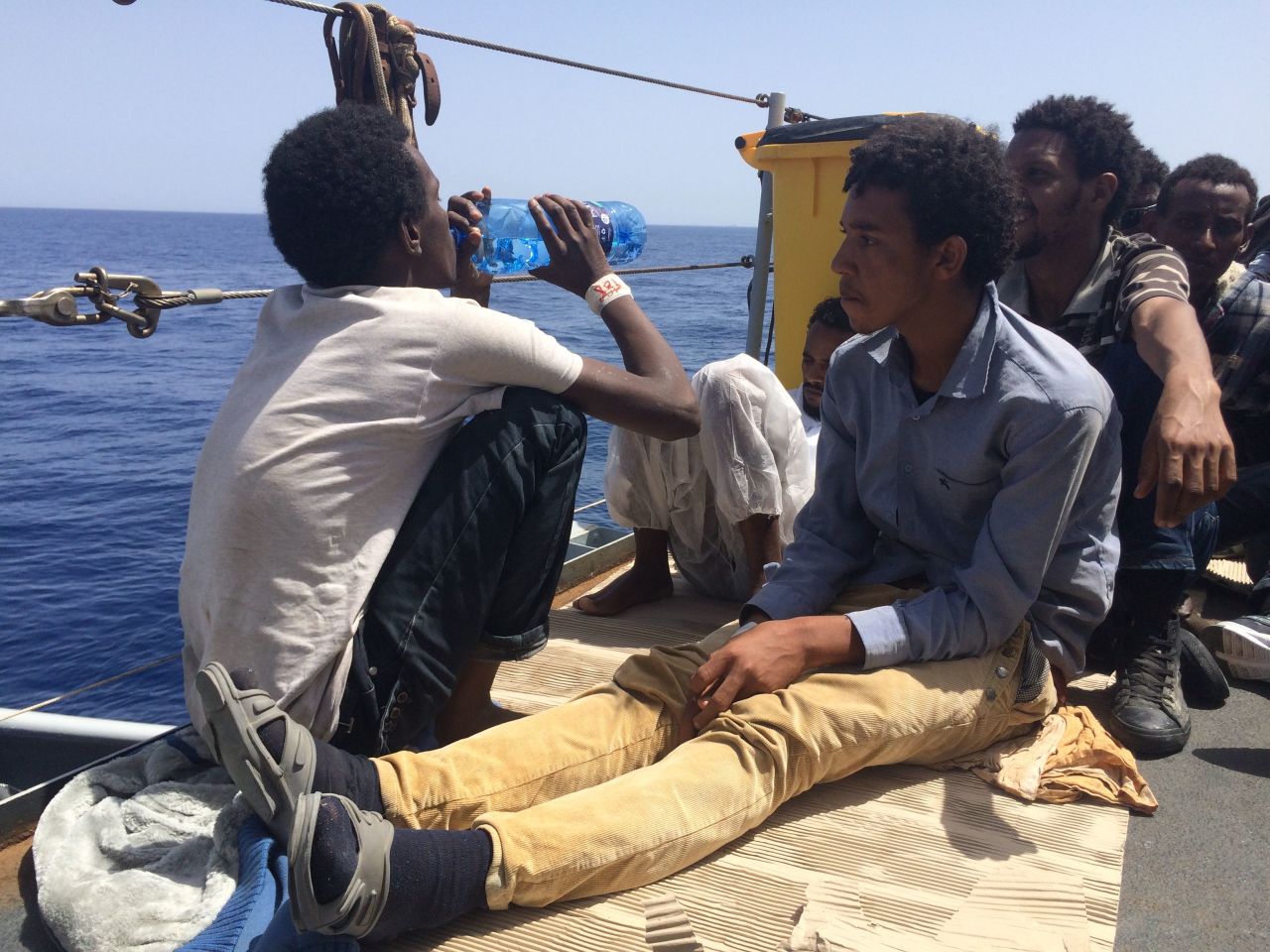 Surrounded by water with nothing to drink: Dehydration can be a serious problem for those who attempt the sea crossing. Here, a man drinks after being brought onboard by the Italian Navy.