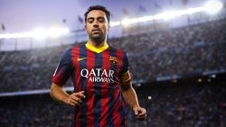 Beneath the lights of home: Xavi Hernandez in action for Barcelona at the Camp Nou.