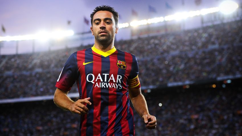 Beneath the lights of home: Xavi Hernandez in action for Barcelona at the Camp Nou.