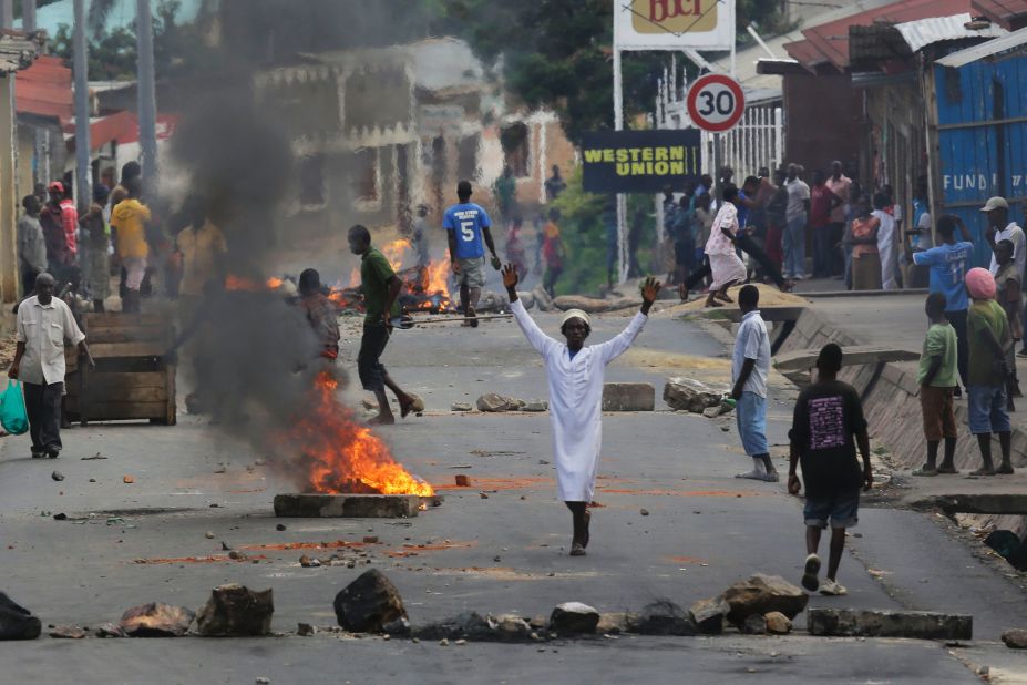 A protester stands by a burning barricade in Bujumbura on May 21.