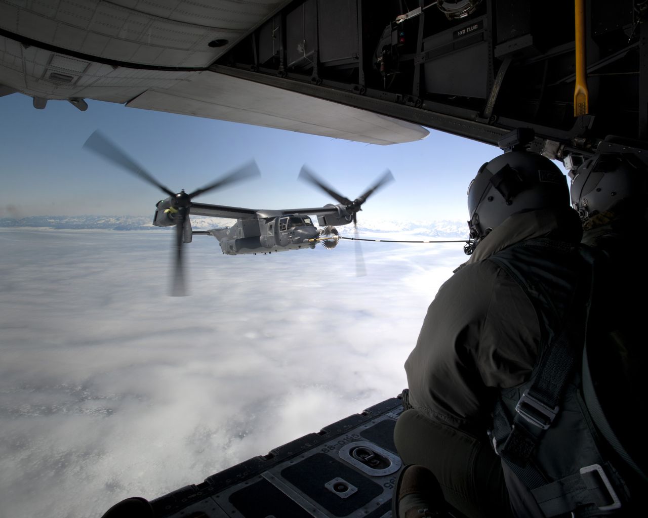 A CV-22B Osprey receives fuel from an MC-130H Combat Talon II on June 21, 2013, off the coast of Greenland.