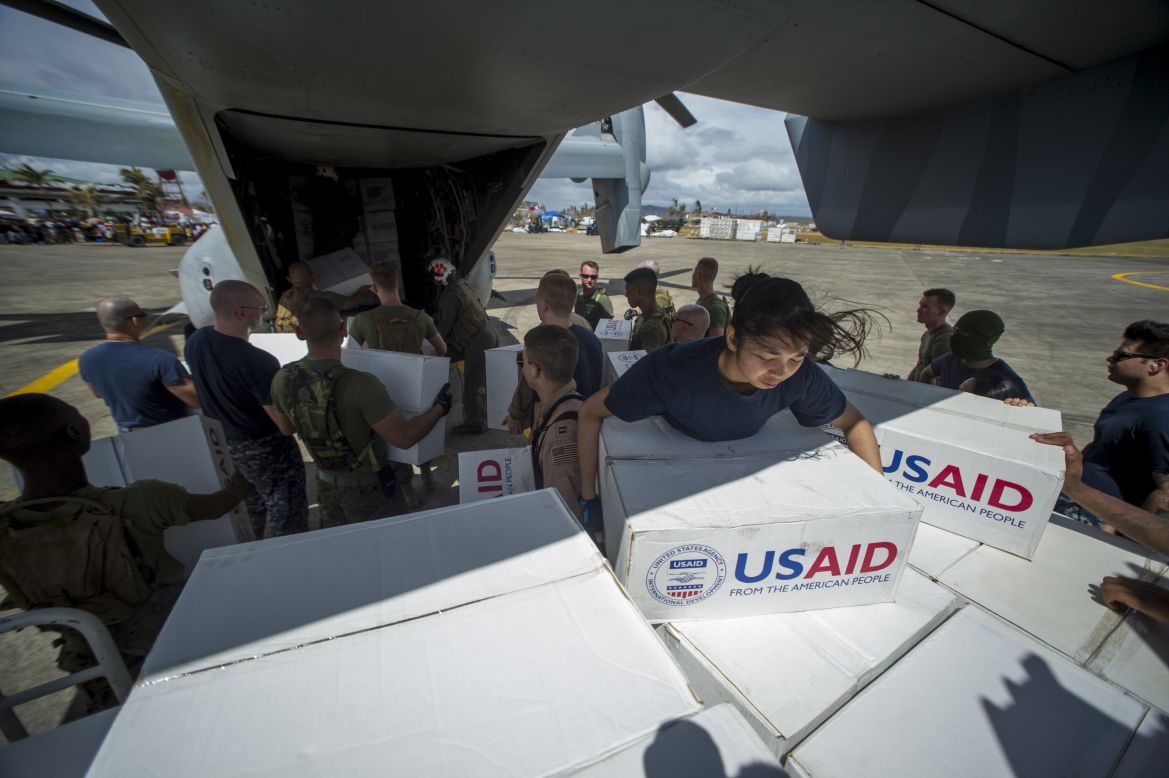 Sailors assigned to the aircraft carrier USS George Washington (CVN 73) and Marines assigned to the 3d Marine Expeditionary Brigade load boxes of supplies into a U.S. Marine Corps MV-22 Osprey from Marine Medium Tiltrotor Squadron (VMM) 262 to be airlifted to nearby villages during relief efforts after Supertyphoon Haiyan.