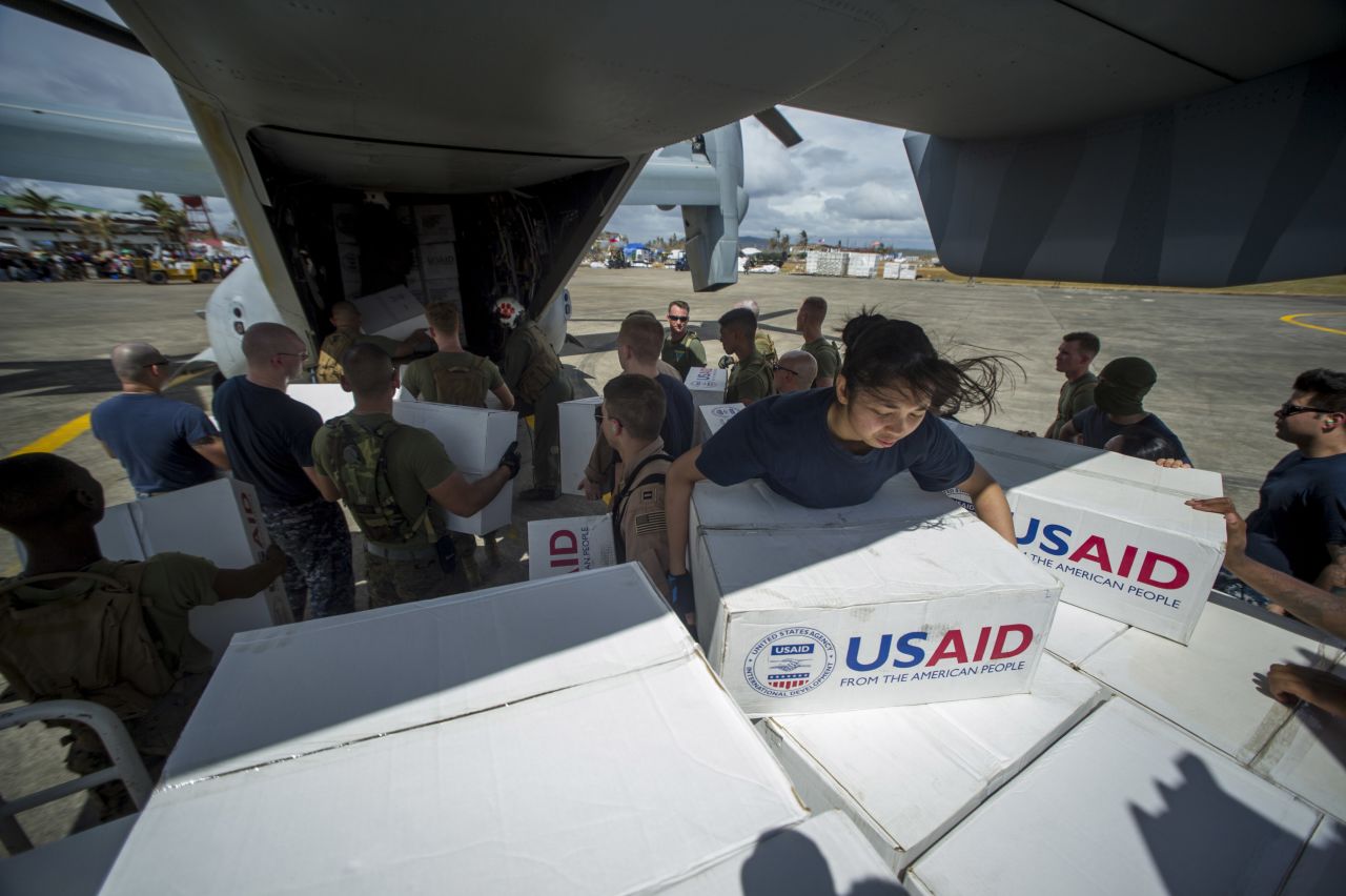 Sailors assigned to the aircraft carrier USS George Washington (CVN 73) and Marines assigned to the 3d Marine Expeditionary Brigade load boxes of supplies into a U.S. Marine Corps MV-22 Osprey from Marine Medium Tiltrotor Squadron (VMM) 262 to be airlifted to nearby villages during relief efforts after Supertyphoon Haiyan.