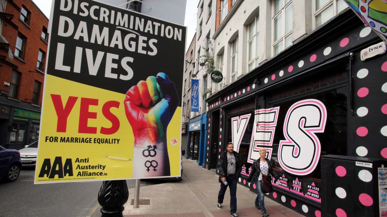 Pedestrians walk past a mural in favour of same-sex marriages in Dublin on May 21, 2015. Ireland goes to the polls tomorrow to vote on whether same-sex marriage should be legal, in a referendum that has exposed sharp divisions between communities in this traditionally Catholic nation. AFP PHOTO / PAUL FAITHPAUL FAITH/AFP/Getty Images