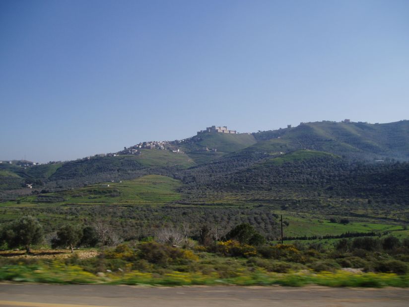 The Crac de Chavaliers is pictured from afar on a hilltop.