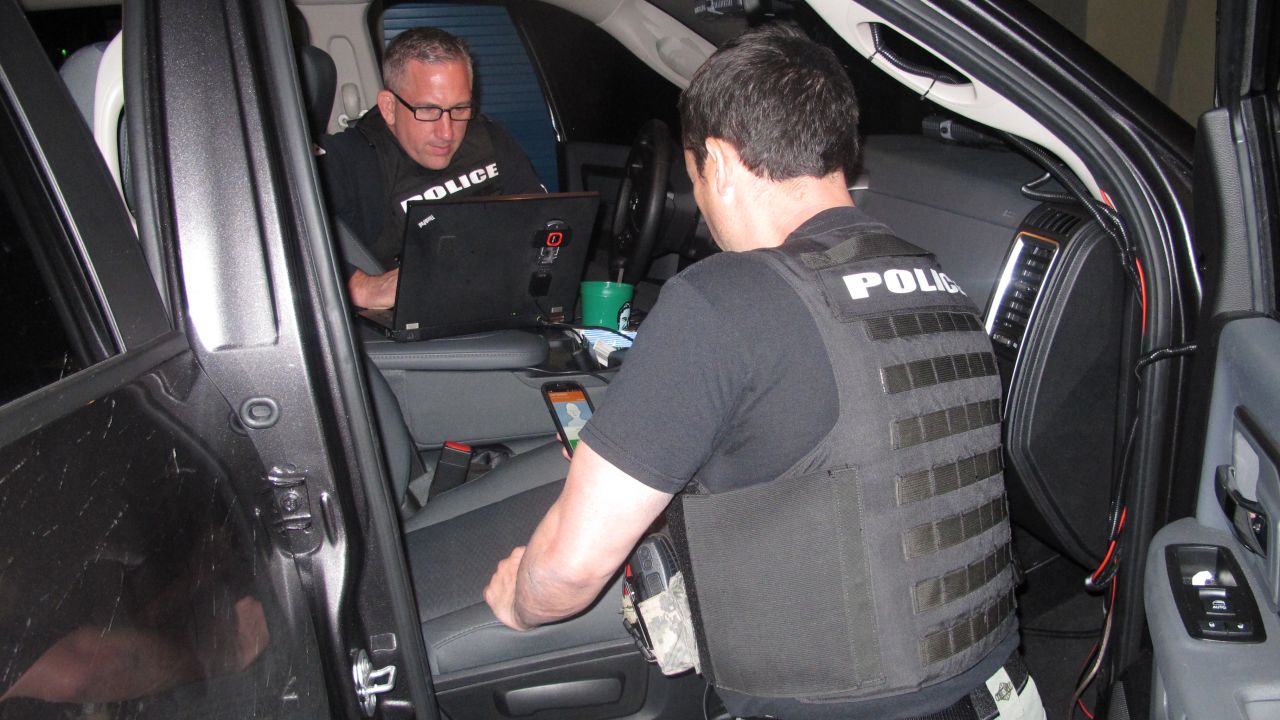 Catlin, left, and Edward Garcia investigate fraud cases. South Florida has become a national hub for such activity.