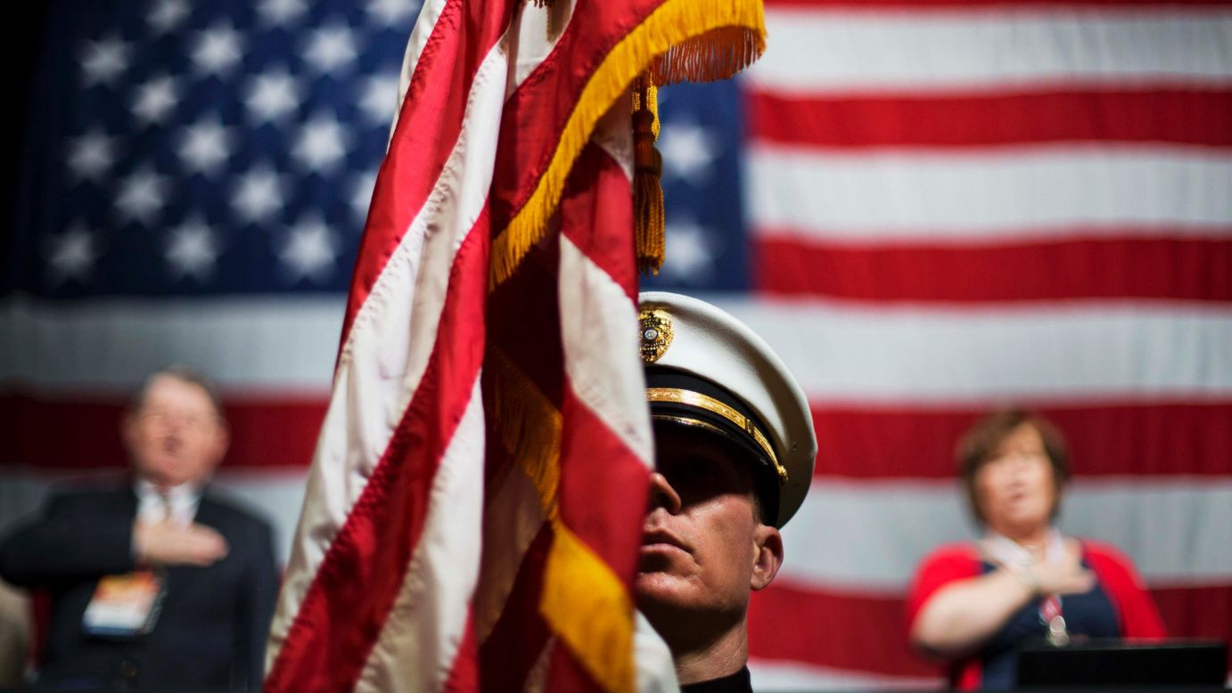 Officer Chris Armel of the Athens-Clarke County Police Department holds an American flag while the Pledge of Allegiance is recited Friday, May 15, at the Georgia Republican Convention in Athens, Georgia.