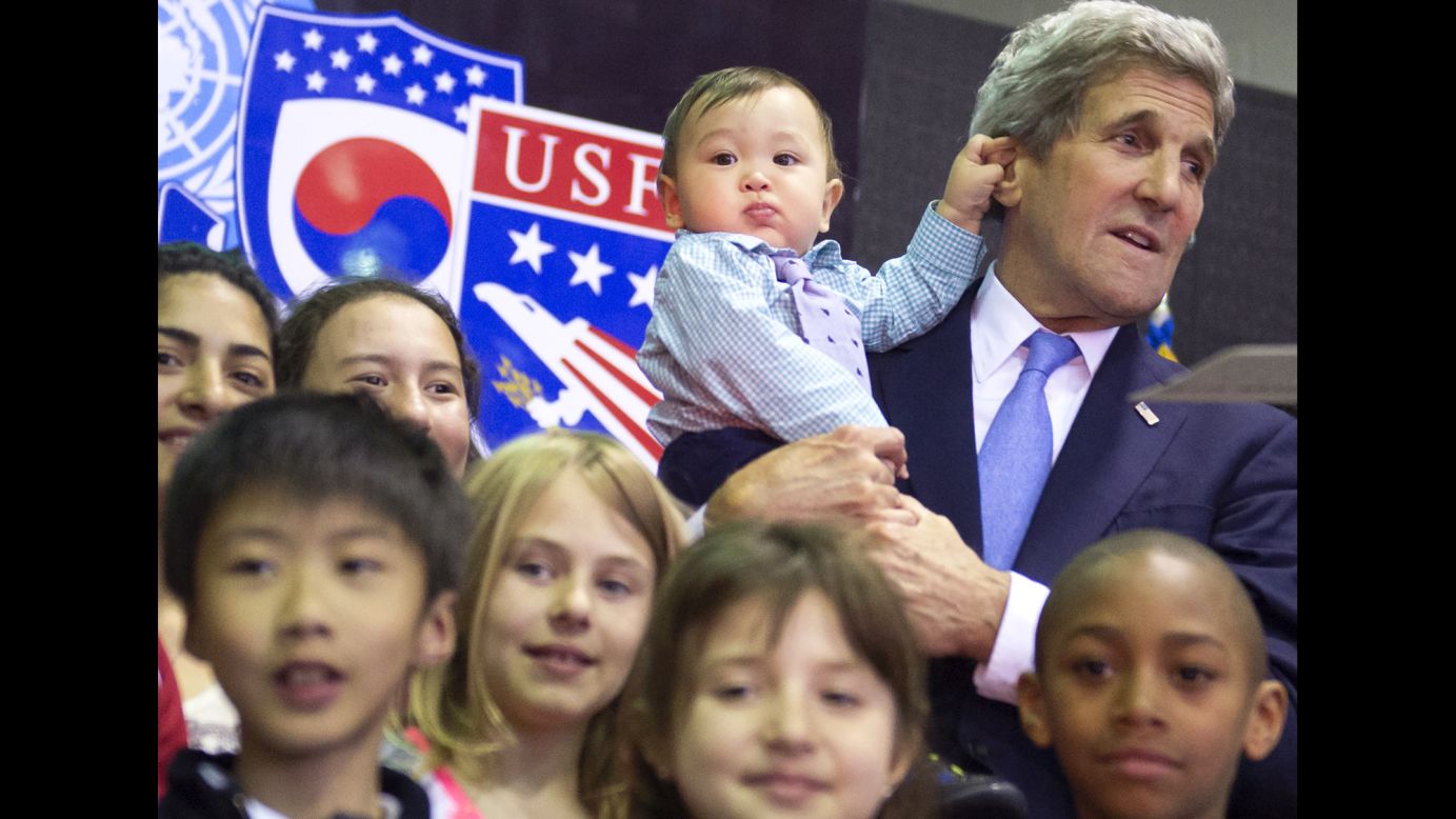 U.S. Secretary of State John Kerry holds 8-month-old Andrew Belz as he poses for photos with the children of U.S. troops and U.S. Embassy personnel in Seoul, South Korea, on Monday, May 18.