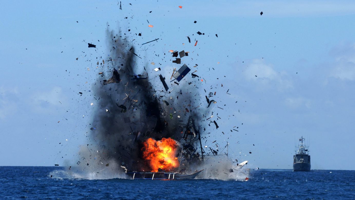 An Indonesian Navy ship blows up a foreign fishing vessel near Bitung, Indonesia, on Wednesday, May 20. According to media reports, Indonesia has sunk dozens of foreign boats across the country as part of an ongoing push to stop illegal fishing in its waters.