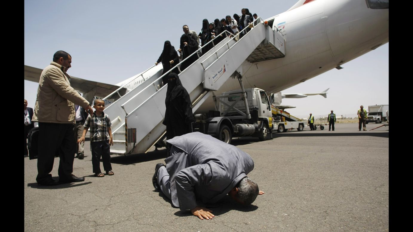A Yemeni man who was stranded in Egypt after <a href="http://www.cnn.com/2015/01/20/world/gallery/yemen-unrest/index.html" target="_blank">conflict broke out in his home country</a> prays and kisses the ground after arriving at the airport in Sanaa, Yemen, on Wednesday, May 20. A Saudi-led coalition has been carrying out airstrikes against Houthi rebels in Yemen since Yemen's President fled the country in late March.