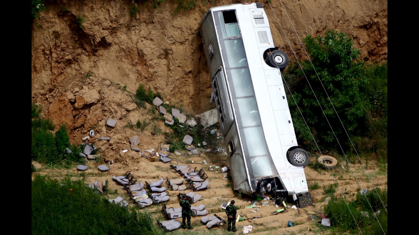 The remains of a bus are seen after a deadly crash in Xianyang, China, on Friday, May 15. At least 35 people were killed when the bus carrying 46 people plunged into a ravine, according to the Xinhua News Agency.