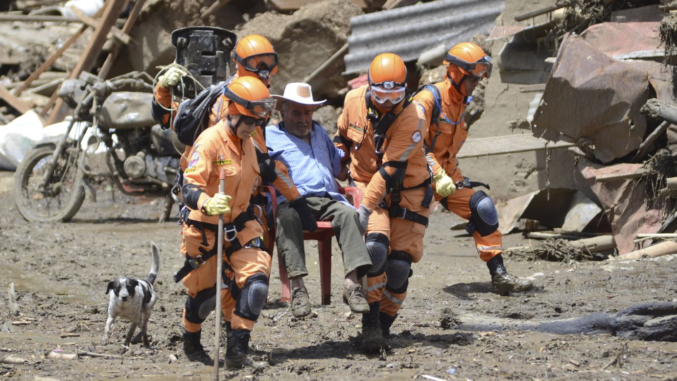 Rescue workers help a man after <a href="http://www.cnn.com/2015/05/19/world/gallery/colombia-landslide/index.html" target="_blank">a deadly landslide in Salgar, Colombia,</a> on Tuesday, May 19. The landslide tore through a ravine one day earlier, killing more than 80 people, officials said.
