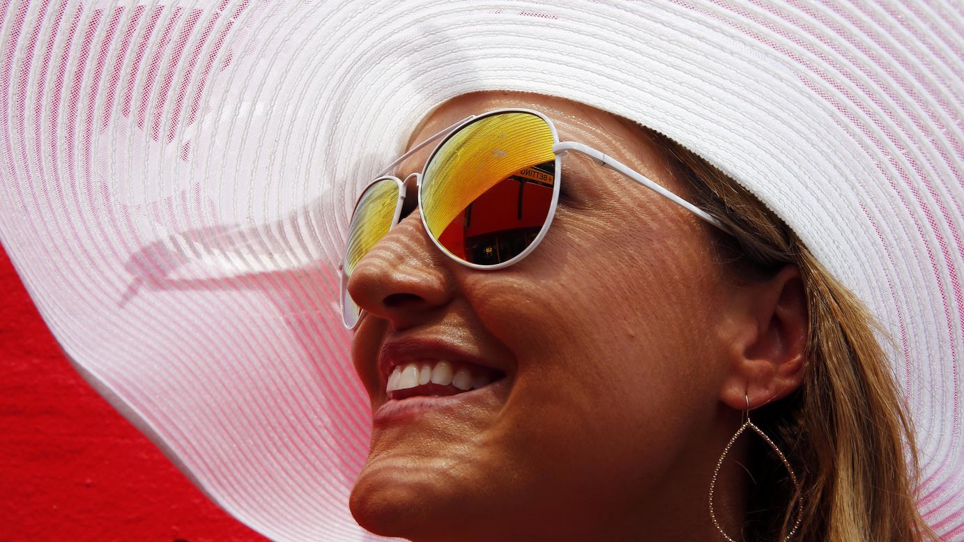 A woman waits for the start of the Preakness horse race Saturday, May 16, in Baltimore.