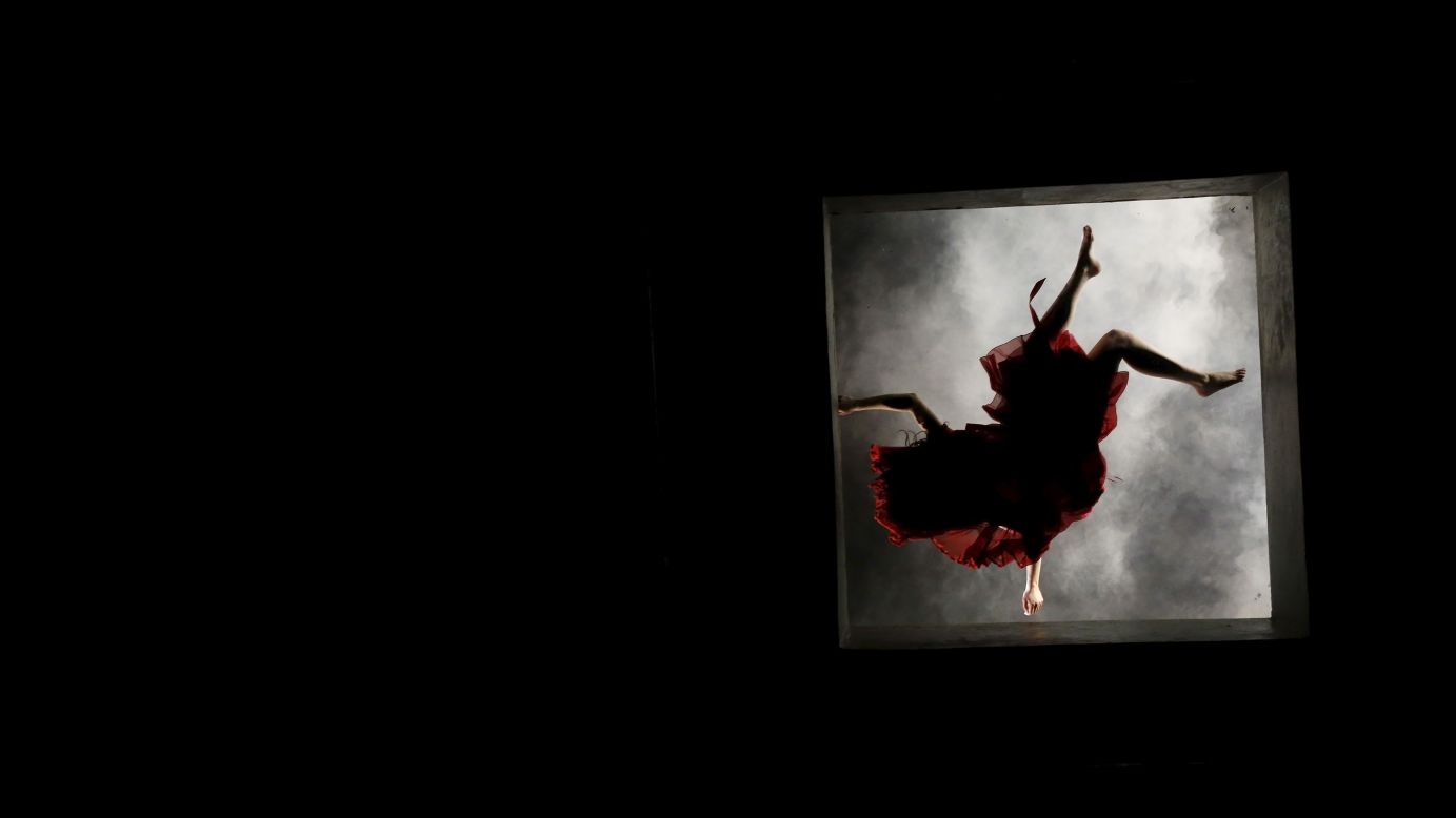 A dancer in Sao Paulo, Brazil, performs on a glass ceiling Saturday, May 16, during "Claraboia (Skylight)," a creation by choreographer and dancer Morena Nascimento.