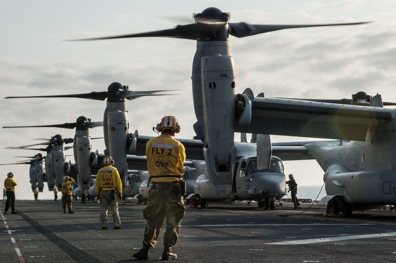 Sailors and Marines prepare to launch MV-22 Osprey tilt-rotor aircraft assigned to Marine Medium Tiltrotor Squadron (VMM) 262 (Reinforced) from the flight deck of the amphibious assault ship USS Bonhomme Richard (LHD 6).