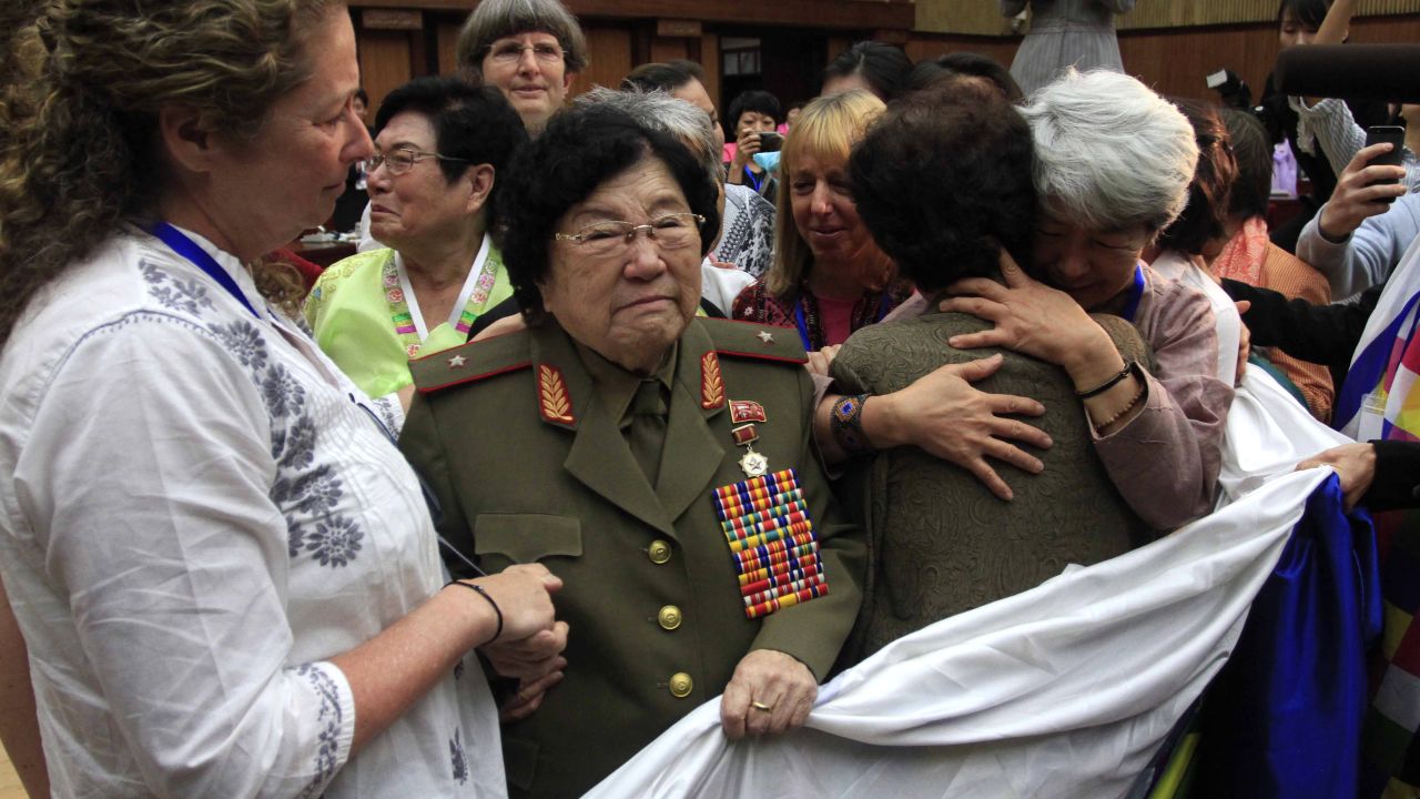 Documentary filmmaker Abigail Disney of the United States, left, shakes the hands of Jon Ku Gang, 68, second left, a North Korean woman who shared her experiences during the Korean War, at a meeting held at the People's Palace of Culture, Thursday, May 21, 2015, in Pyongyang, North Korea. 
