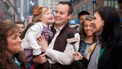Hilaria Baldwin (R) interviews Josh Duggar and his daughter during their visit with "Extra" in Times Square on March 11, 2013
