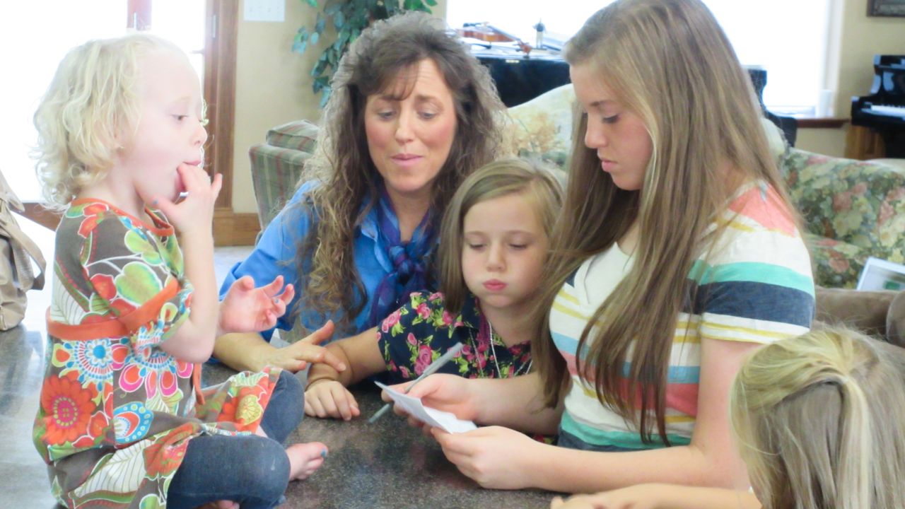 Four of the Duggar girls with their mother, Michelle.