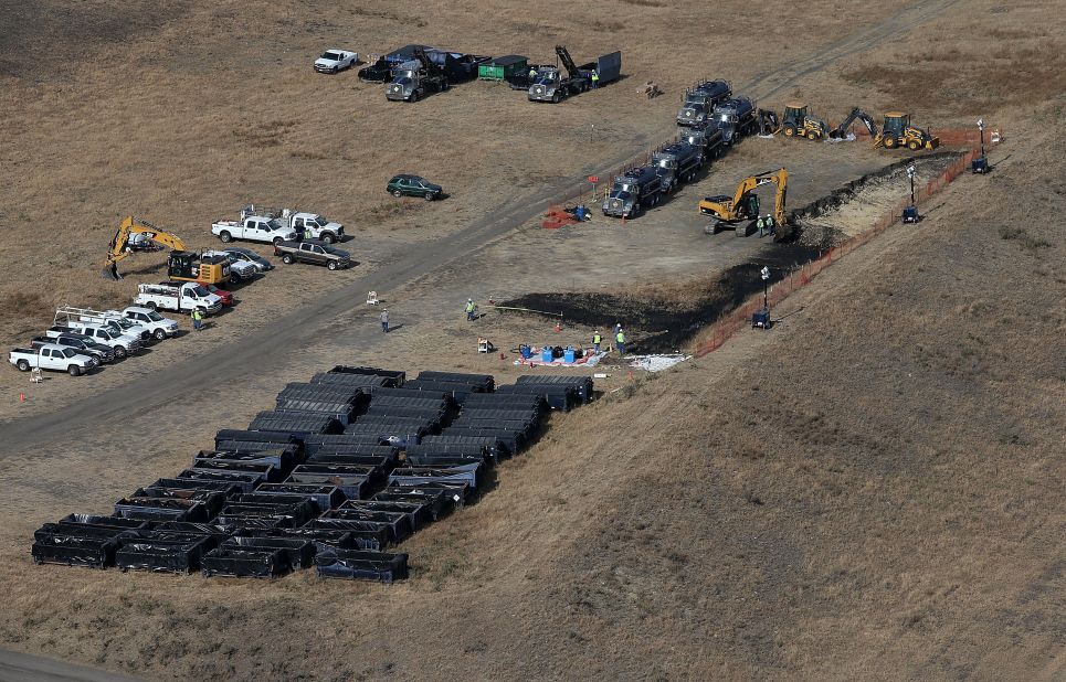 Workers clean up the site near Refugio State Beach on May 21.