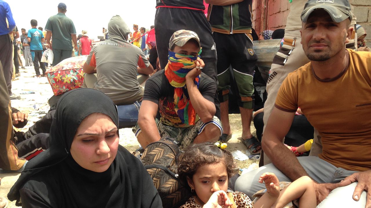 A family waits on the Bzebiz Bridge as they try to flee Iraq's Anbar province, where the militant group ISIS has made recent gains. The family has been displaced five times in the past year and half, failing to find safe areas away from ISIS.