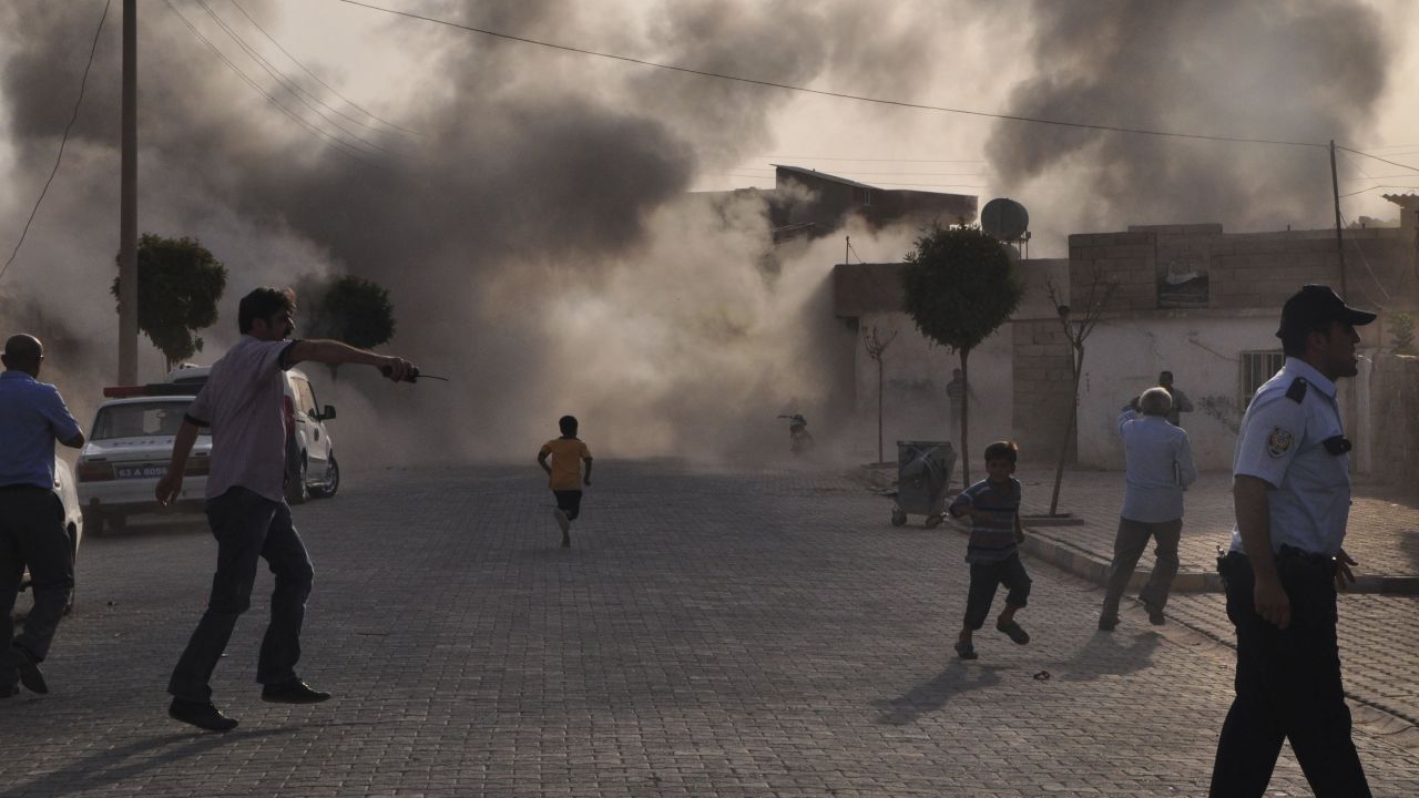 Smoke rises over the streets after a mortar bomb from Syria landed in the Turkish border village of Akcakale on October 3, 2012. Five people were killed. In response, Turkey fired on Syrian targets and its parliament authorized a resolution giving the government permission to deploy soldiers to foreign countries.
