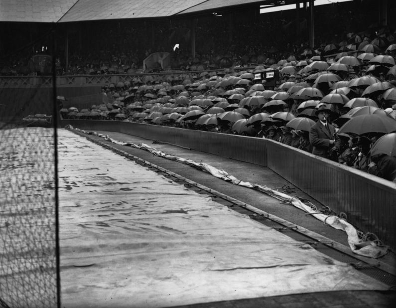Some things never change -- the covers are on and the rain is falling. This example is on Centre Court during the 1922 tournament.