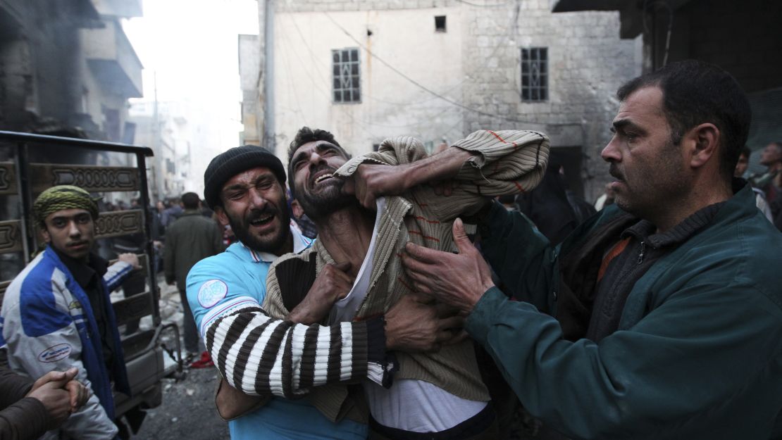 A father reacts after the death of two of his children whom activists said were killed by shelling from forces loyal to al-Assad in Aleppo on January 3, 2013.